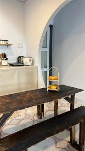 a wooden table with a basket of bread on it at Nồm House in Nha Trang +4 photos