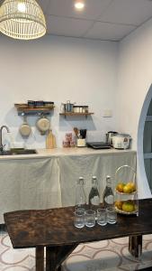 a kitchen with a table with water bottles on it at Nồm House in Nha Trang