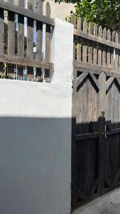 a wooden fence with a wooden gate at Nồm House in Nha Trang