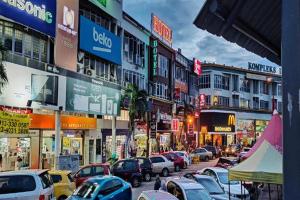 a busy city street filled with lots of parked cars at Fast Hotel Idaman Near To IIUM KL in Kuala Lumpur