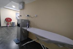 a hospital room with a table and a machine at Fast Hotel Idaman Near To IIUM KL in Kuala Lumpur +82 photos