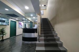 a stairway in a building with a lobby with a staircase at Fast Hotel Idaman Near To IIUM KL in Kuala Lumpur