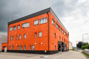 an orange brick building with a black at Wels Inn Hotel in Wels