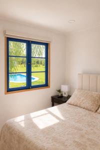 a bedroom with a bed and a window at Alojamiento en Paine cerca Monticello in Hijuela Larga +23 photos