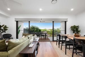 a living room with a couch and a table at Stylish Clontarf Townhouse & Parking in Clontarf