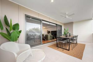 a dining room with a table and chairs at Stylish Clontarf Townhouse & Parking in Clontarf