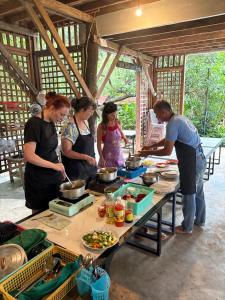 a group of people standing around a table preparing food at Eco Lotus Kampot in Kampot +35 photos