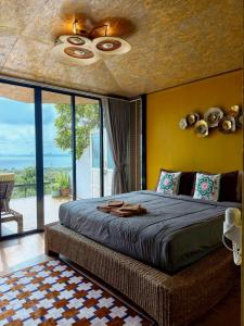 a bedroom with a bed with a ceiling fan at Baan Sahai Tone บ้านสหายโทน in Ko Larn +68 photos
