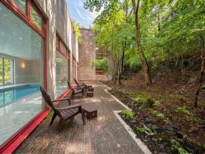 a patio with benches and a swimming pool on a house at LiVEMAX Golf Club Tochigi in Kanuma