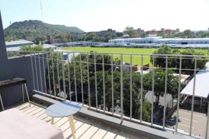 a balcony with a view of a baseball field at Penthouse in Bloemfontein