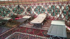 a room with tables and chairs and a patterned wall at Актан in Chong-Kyzylsu