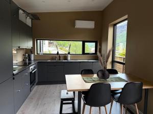 a kitchen with a table and chairs and a window at Aurora Apartments - Stryn View in Stryn