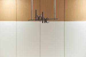 a chandelier with scissors on top of white cabinets at Hohe City Dongdaemun in Seoul