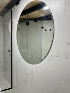 a mirror on a wall in a bathroom at A corner by the sea in Ashdod