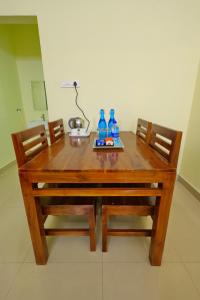 a wooden table with two bottles of water on it at Hotel Shree Laksha Residency Madurai in Madurai