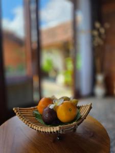 a bowl of fruit sitting on top of a table at Pondok Kumpi ubud in Ubud