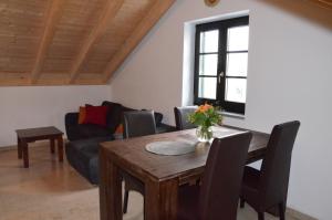 a living room with a wooden table and a couch at Ferienwohnung Emmert Landshut in Landshut
