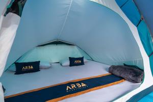 a bed in a tent with two pillows at WWS Cabin By ARBA in Palayangan