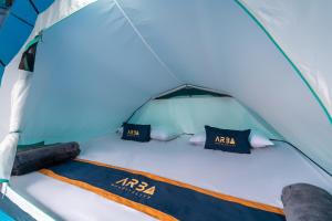 a bed in a tent with two pillows at WWS Cabin By ARBA in Palayangan +11 photos