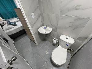 a small bathroom with a toilet and a sink at Limsor Town Apartaestudios in San Andrés +18 photos