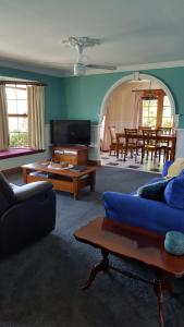 a living room with a blue couch and a table at Maria's at Swansea in Swansea