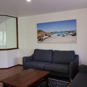 a living room with a couch and a table at Siesta Park Holiday Resort ABSOLUTE BEACHFRONT RESORT in Busselton