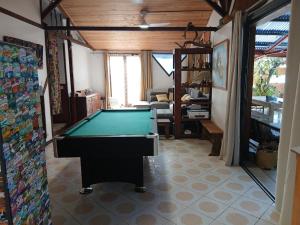 a pool table in the middle of a living room at maison entière in Saint-Pierre