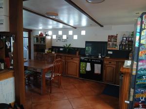 a kitchen with a wooden table and a table and chairs at maison entière in Saint-Pierre