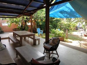 a patio with a table and chairs and an umbrella at maison entière in Saint-Pierre