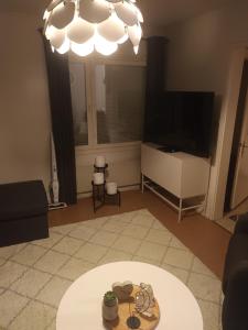 a living room with a chandelier and a table at Peaceful Comfort in Suni
