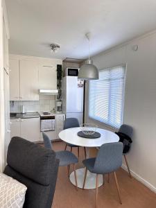a kitchen and dining room with a table and chairs at Peaceful Comfort in Suni