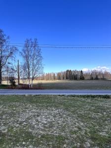an empty road next to a field of grass at Peaceful Comfort in Suni