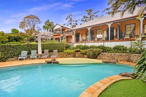 a swimming pool in front of a house at Montville Boutique BnB in Montville