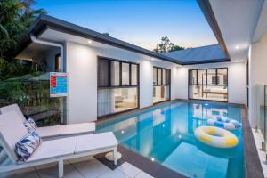 a swimming pool in a house at Belle Escapes Sandcastles in Palm Cove