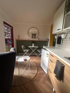 a kitchen with a white refrigerator and a table at Cosy and Pet Friendly Blackheath Studio 2 in Blackheath