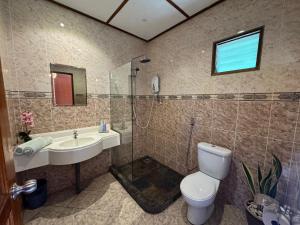 a bathroom with a toilet and a sink and a shower at Minang Cove Resort in Tioman Island +141 photos