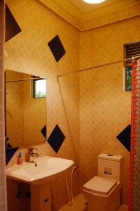 a bathroom with a sink and a toilet at Kamaro Holiday Resorts (Villa) in Bandaragama