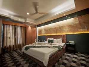 a bedroom with a large bed in a room at Sylhet Paradise Inn in Sylhet