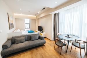 a living room with a couch and a table at May Seven Hotel and Suites in Ulaanbaatar