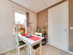 a dining room with a white table and a window at Alluring Apartment in Bergen with Terrace, Garden and BBQ in Bergen