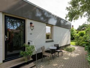 a patio with a table and chairs and a building at Alluring Apartment in Bergen with Terrace, Garden and BBQ in Bergen