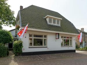 a house with two canadian flags in front of it at Alluring Apartment in Bergen with Terrace, Garden and BBQ in Bergen +24 photos