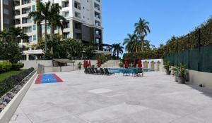 a patio with a table and chairs in a building at Grand Venetian Comfort in Puerto Vallarta