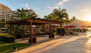 a pavilion with tables and chairs in a park at Grand Venetian Comfort in Puerto Vallarta
