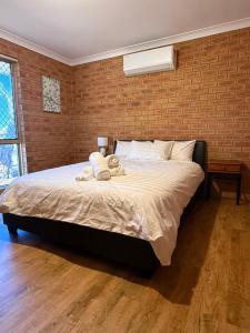 a bedroom with a bed with two towels on it at Good price Apartment self check-in in Geraldton