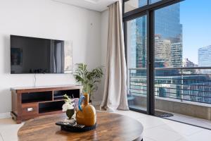 a living room with a table and a large window at Built on Hope De Waterkant in Cape Town