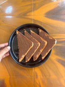 two slices of chocolate cake on a plate on a table at Second Home Stays at Arnav Cottages Alibag in Alibaug