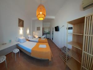 a hotel room with two beds and a staircase at Lydia Mare in Agios Kirykos