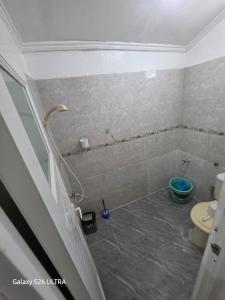a bathroom with a shower and a toilet at Omah Diaz Homestay Malioboro in Jetis