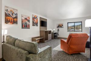 a living room with a couch and a chair at Super 8 by Wyndham Montpelier - Bear Lake in Montpelier